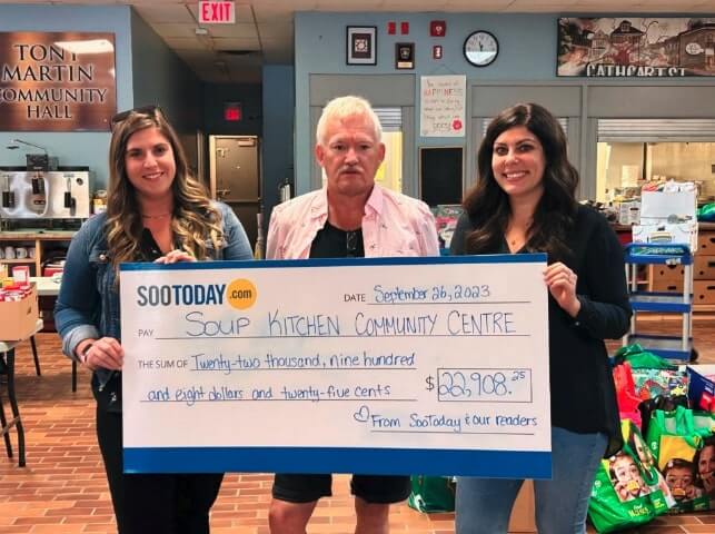 SooToday’s Carissa Boyer and Jasmyn Rowley present Soup Kitchen general manager Ron Sim with the donation from SooToday and our readers