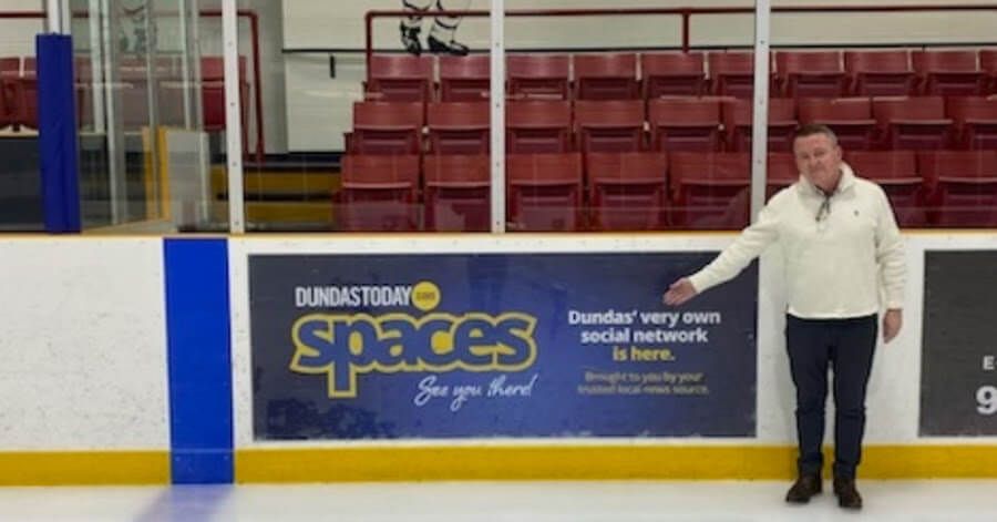 Daniel Coleman pointing at a Dundas Spaces advertisement.