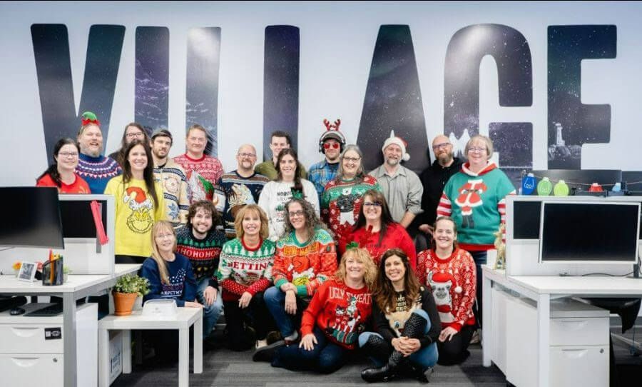 Village Media head office staff show off their ugliest Christmas sweaters to kick off the holiday season