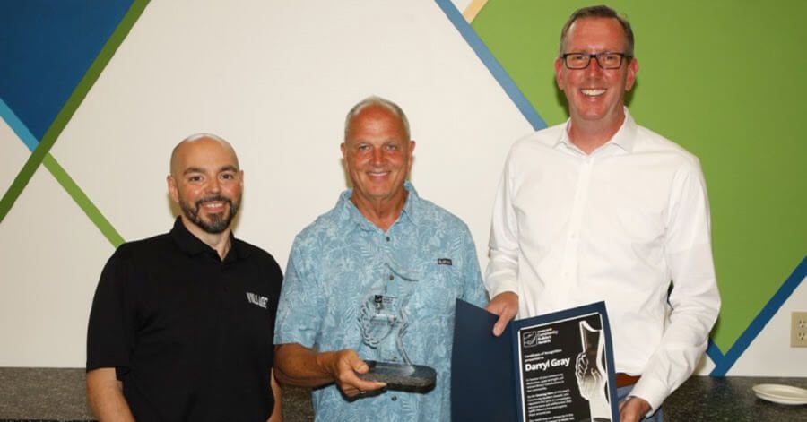 Gary Assis, NewmarketToday community partnership specialist ( left) and Dave Starr, award sponsor (right), present Darryl Gray (centre) with the Unsung Hero Community Builders Award