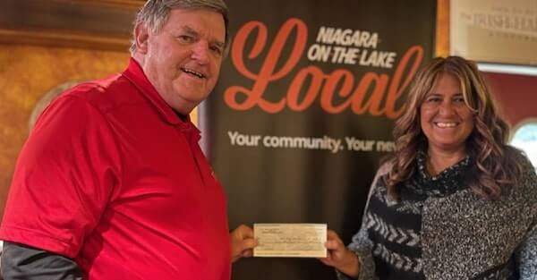 Cheque presentation at a bingo fundraising event for Red Roof Retreat