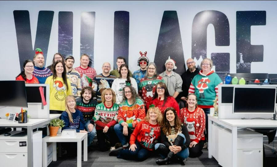 Village Media head office staff show off their ugliest Christmas sweaters to kick off the holiday season