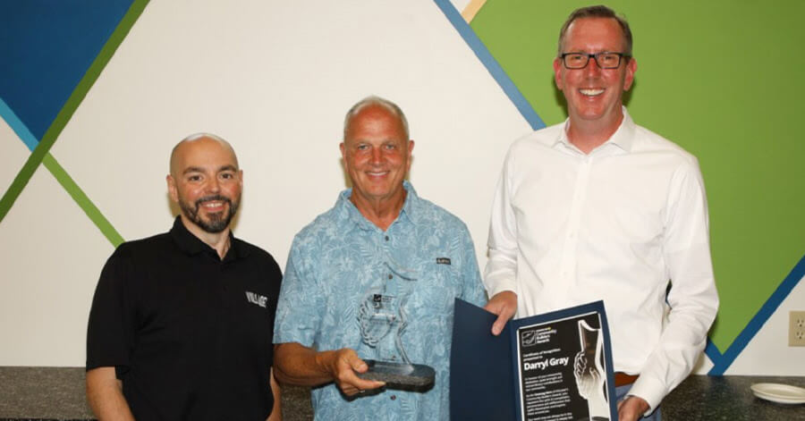 Gary Assis, NewmarketToday community partnership specialist ( left) and Dave Starr, award sponsor (right), present Darryl Gray (centre) with the Unsung Hero Community Builders Award