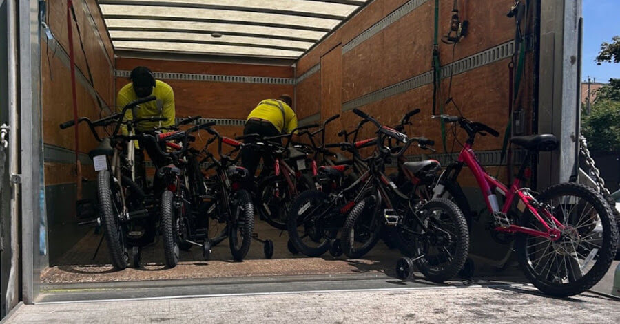 Bikes and other gifts sitting in a truck trailer, waiting to be distributed