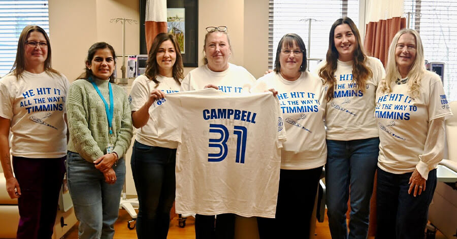 Timmins and District Hospital oncology staff with the reveal t-shirt for the "He hit it all the way to Timmins" t-shirt fundraiser, which brought in over $31,000 for the department