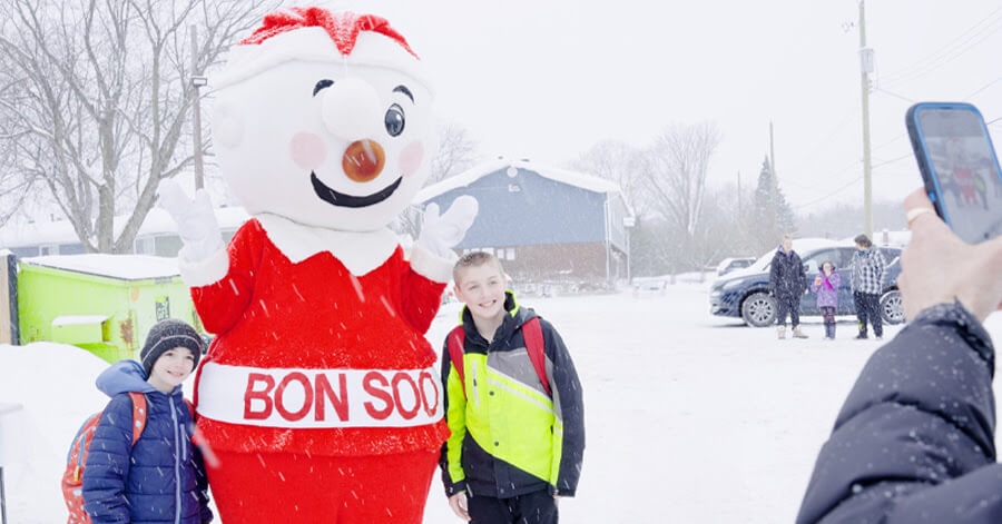 Bon Soo taking a photo with some children