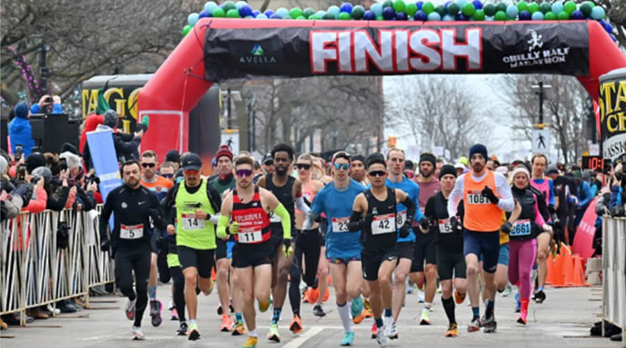 A group of runners pass the finish line at the Chilly Half Marathon in Burlington