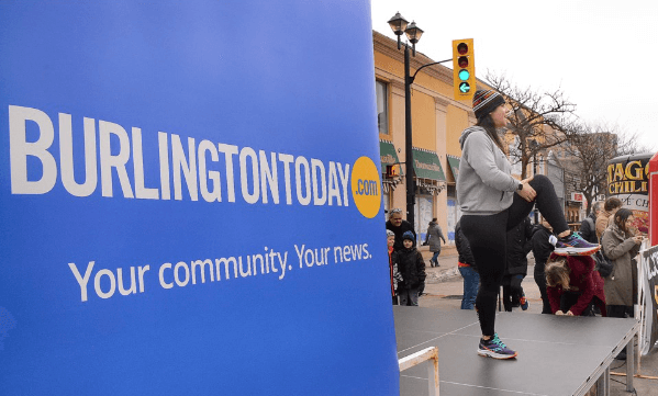 A runner stretches at the Chilly Half Marathon in downtown Burlington