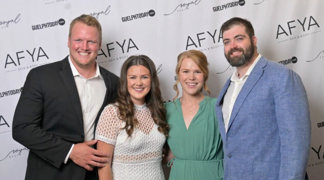 People standing in front of a backdrop at the Big Brothers Big Sisters Royal Reach Gala